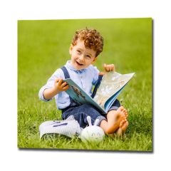 Square photo print of a family photo featuring a small boy reading a book