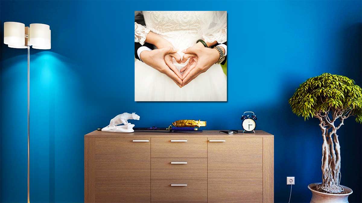 romantic wedding photo hung above a chest of drawers