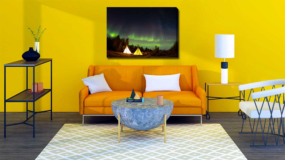Canvas print of the northern lights hung on a bright yellow wall